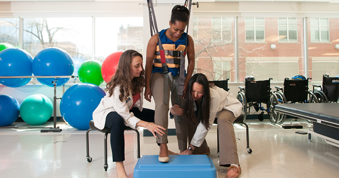 Physical therapists in a clinic working with a patient