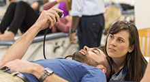 Two PT students practicing clinical skills