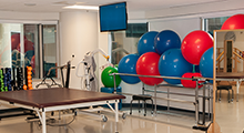 PT clinic with stability balls, mirrors, and tables