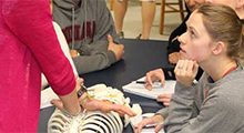 PT students in a clinic learning from a professor