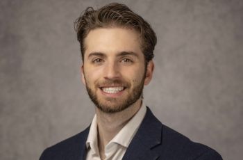 Headshot of gentleman dressed in suit and button up shirt
